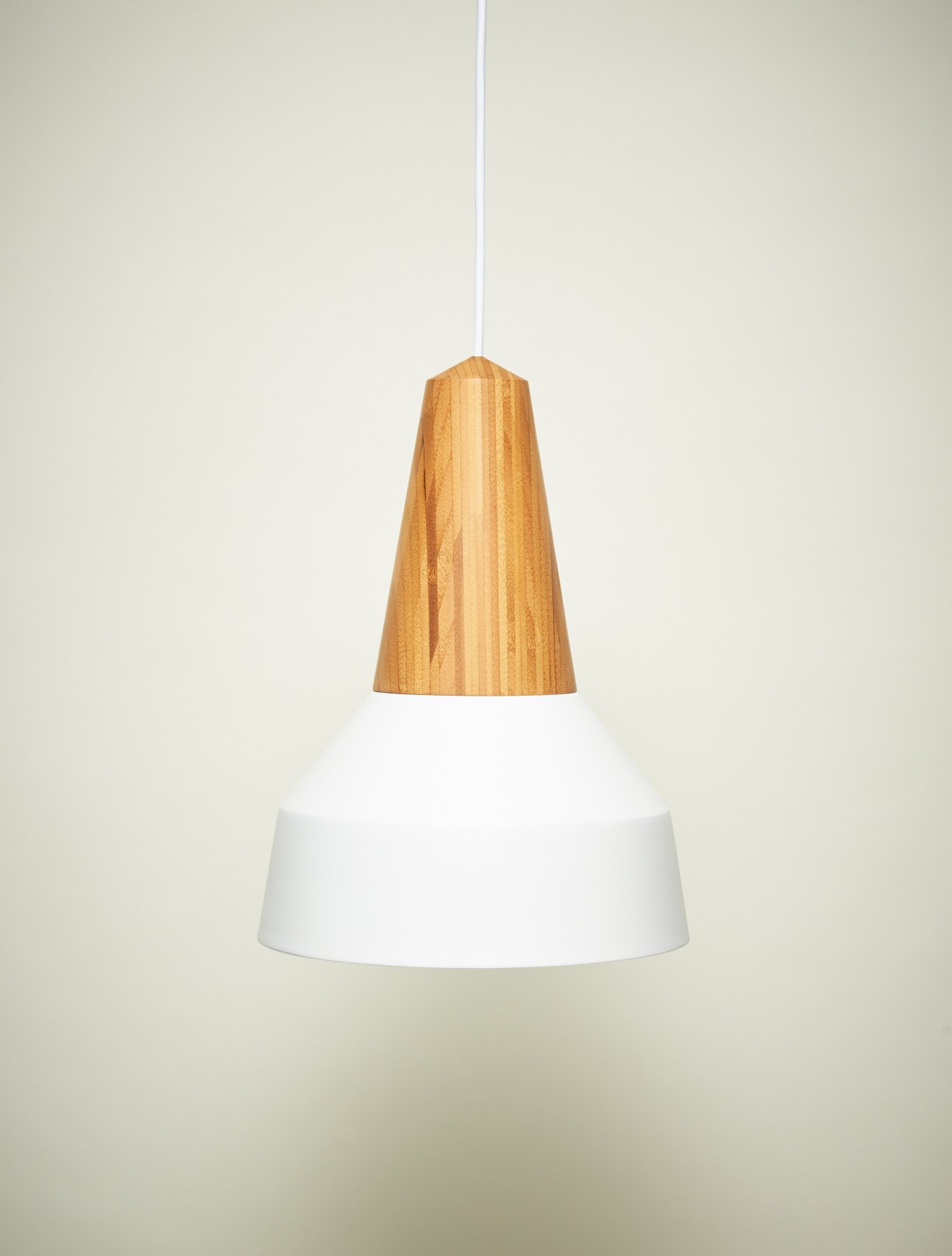 Schneid Ray pendant lamp with hand-turned wooden base in ash and white metal shade suspended by cord.