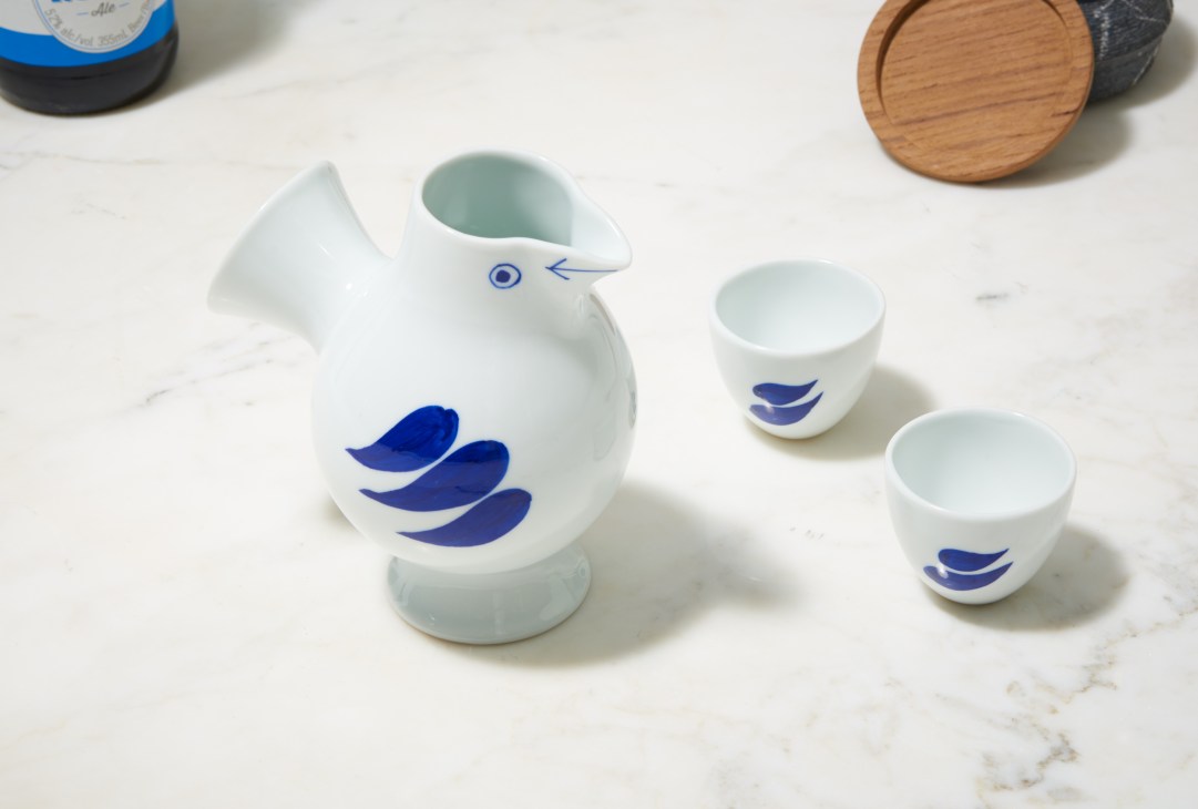 White porcelain saké set with blue leaf design featuring a tokkuri server and ochoko cups by Lisa Larson and Tonkachi.