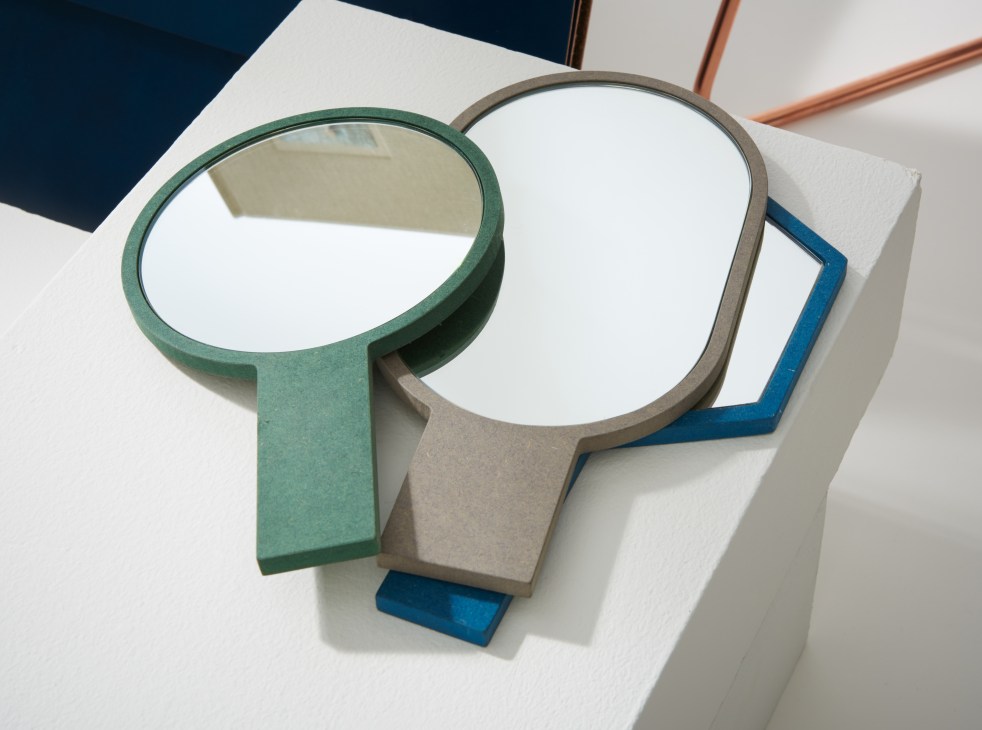 Two geometric wood-fibre mirrors with green and grey frames and mirrored surfaces by MPGMB.