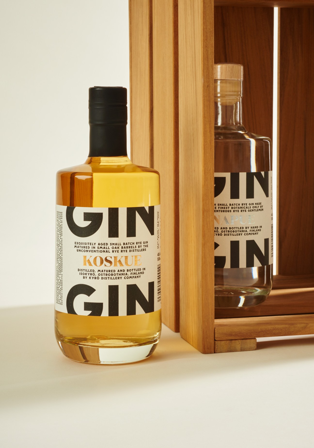 Kyrö Distillery Company rye gin bottle with black cap and wooden display case.