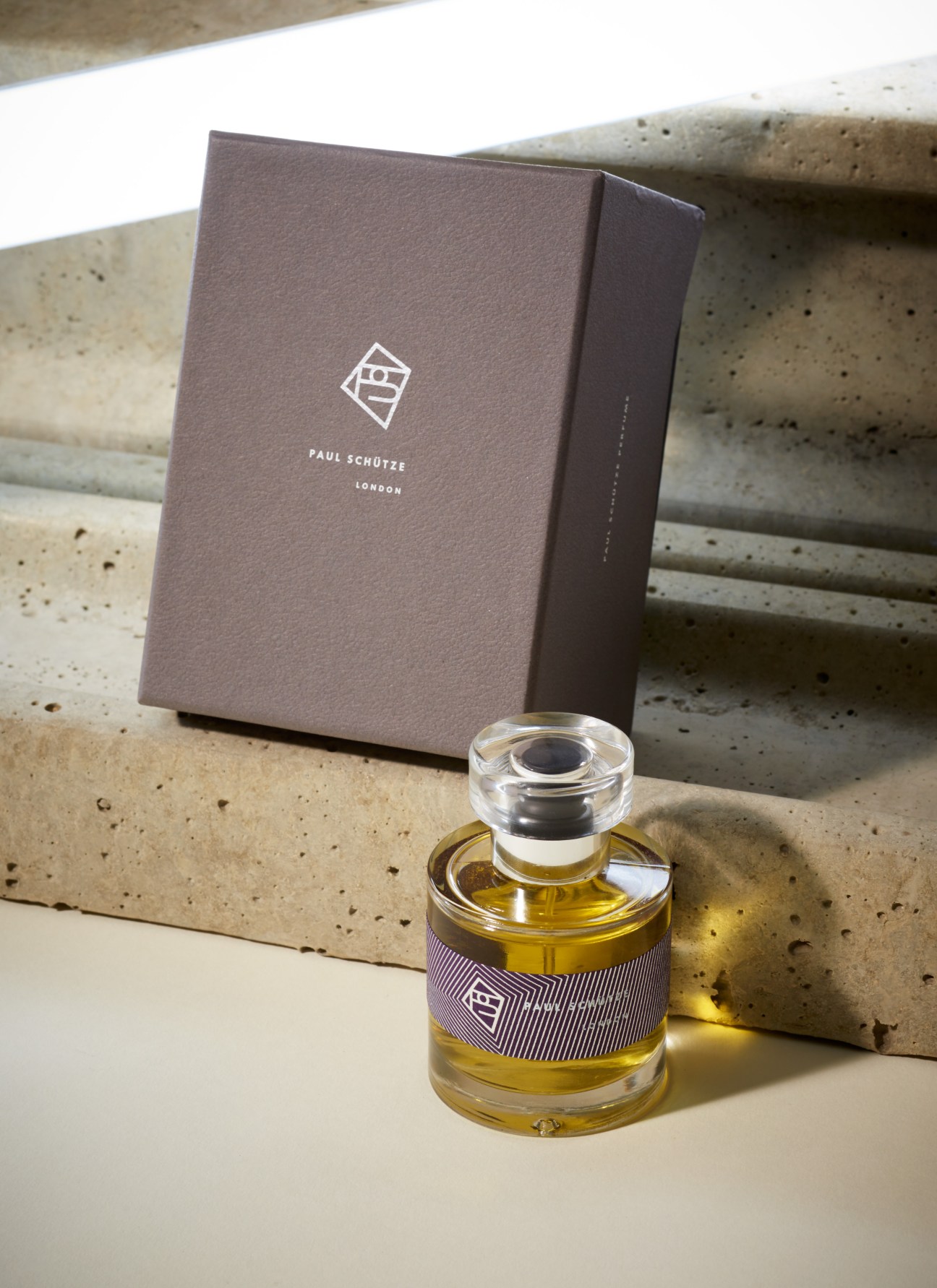 Paul Schütze perfume bottle with branded box displayed on concrete surface