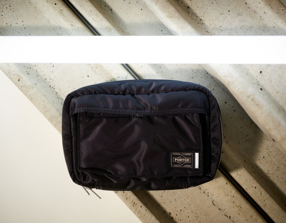 Black Porter X Shiseido Men skincare pouch with branded label on concrete surface.