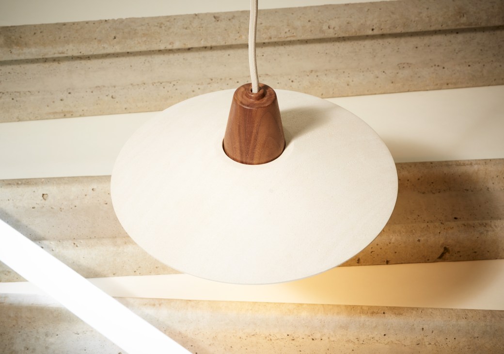 Pendant light by Inkster Maken with white circular shade and wooden cone fixture hanging from cord.