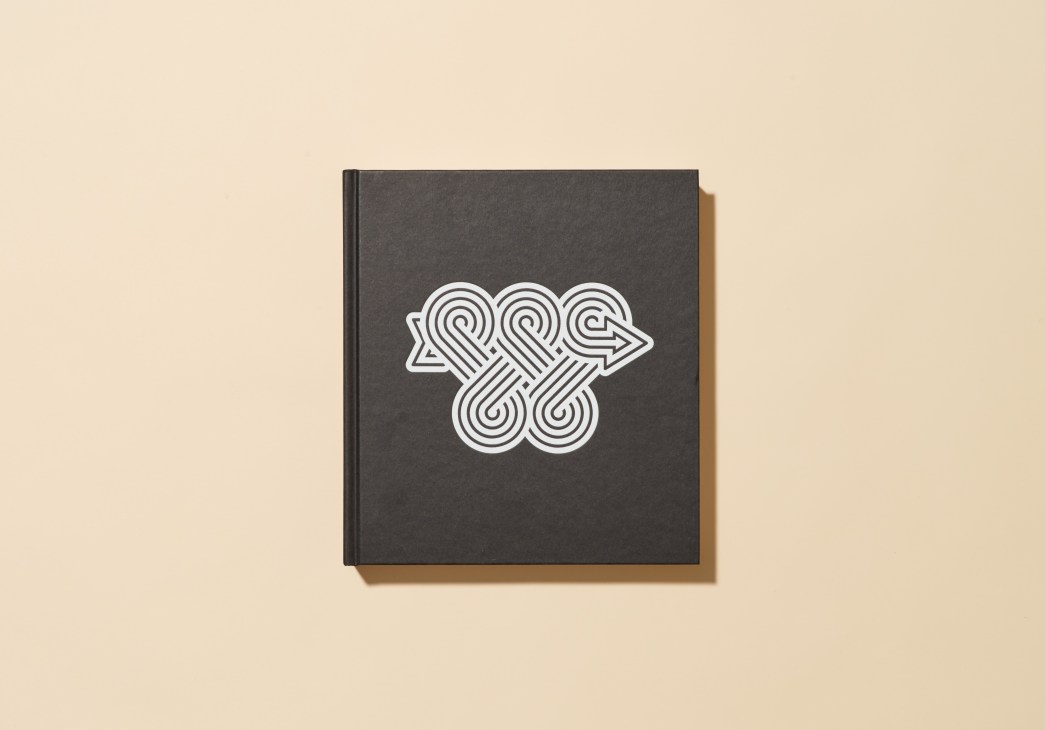 Dark grey book cover with white geometric interlocking pattern design
