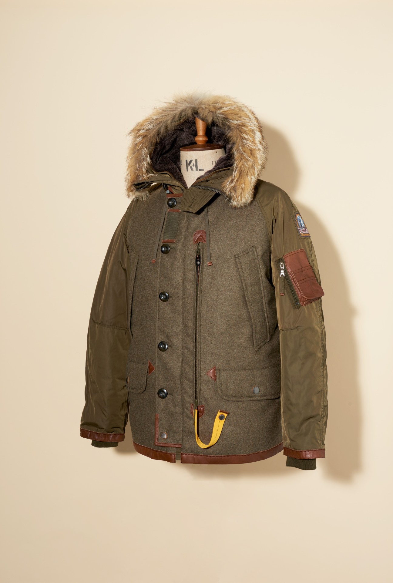 Parajumpers olive-green parka jacket with fur-trimmed hood and leather trim details displayed on a mannequin.