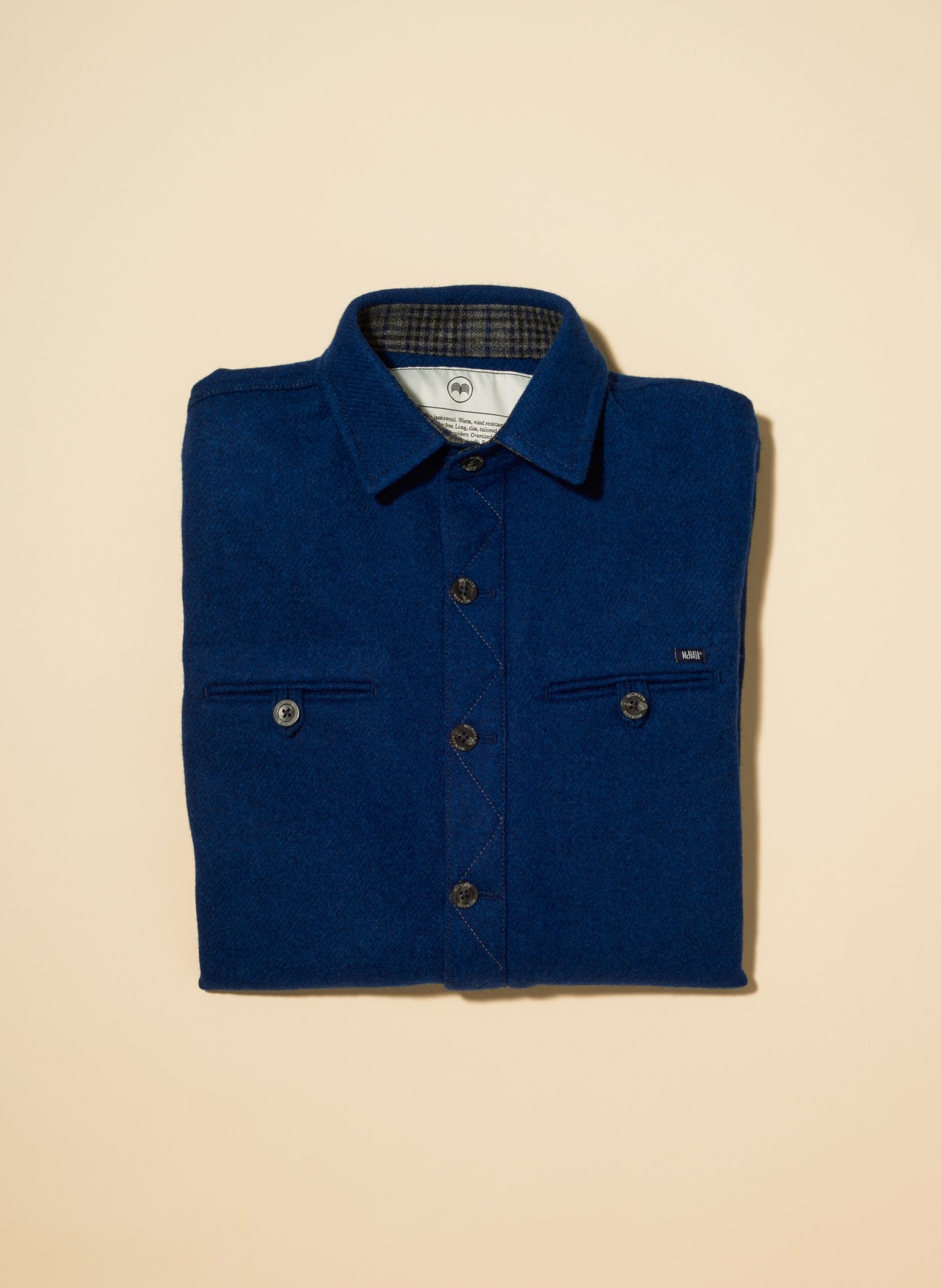 Folded blue wool mountain shirt with collar and button front by McNair.