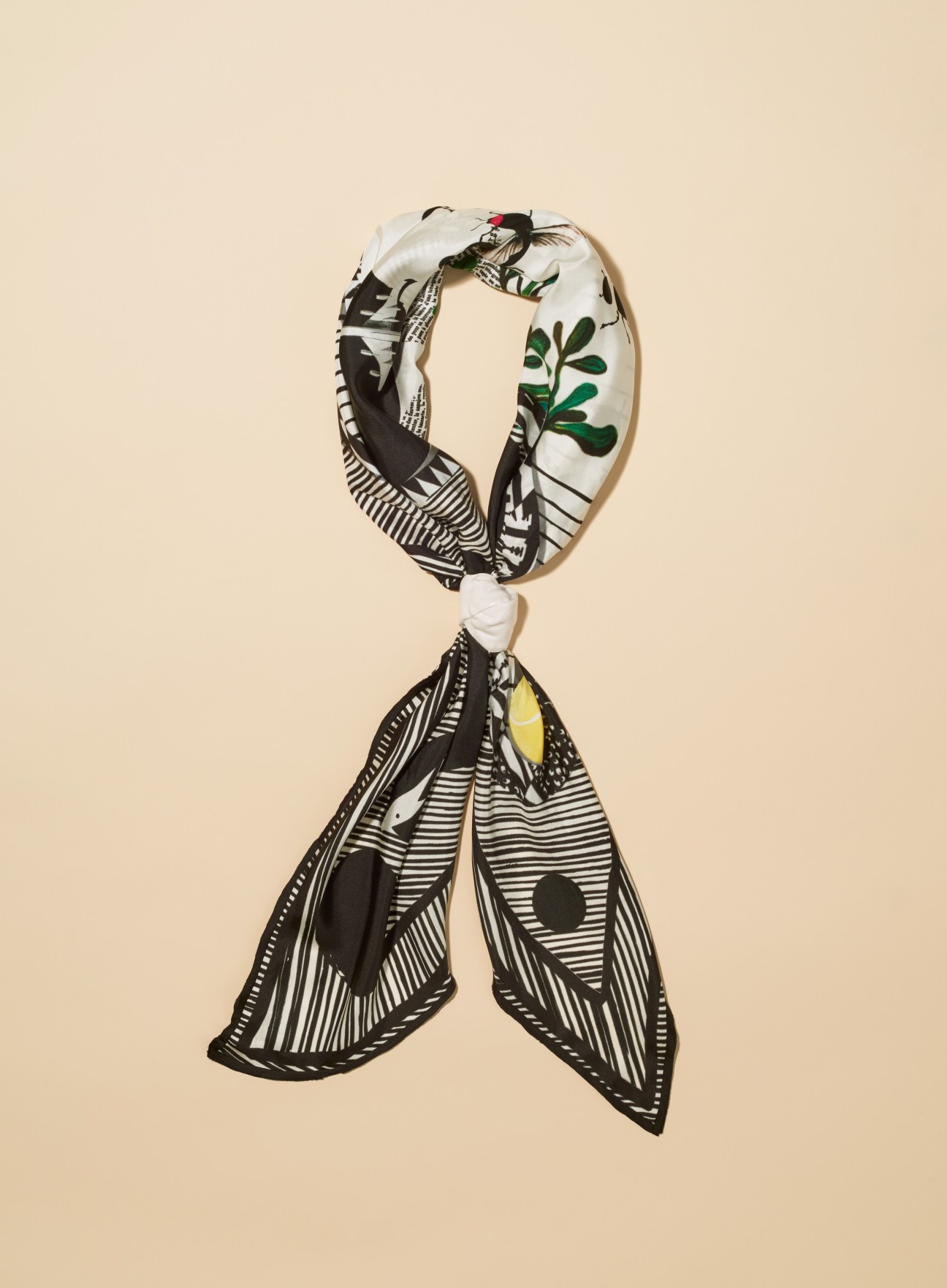 Heart Heart Heart scarf with black and white geometric patterns and green botanical motifs.