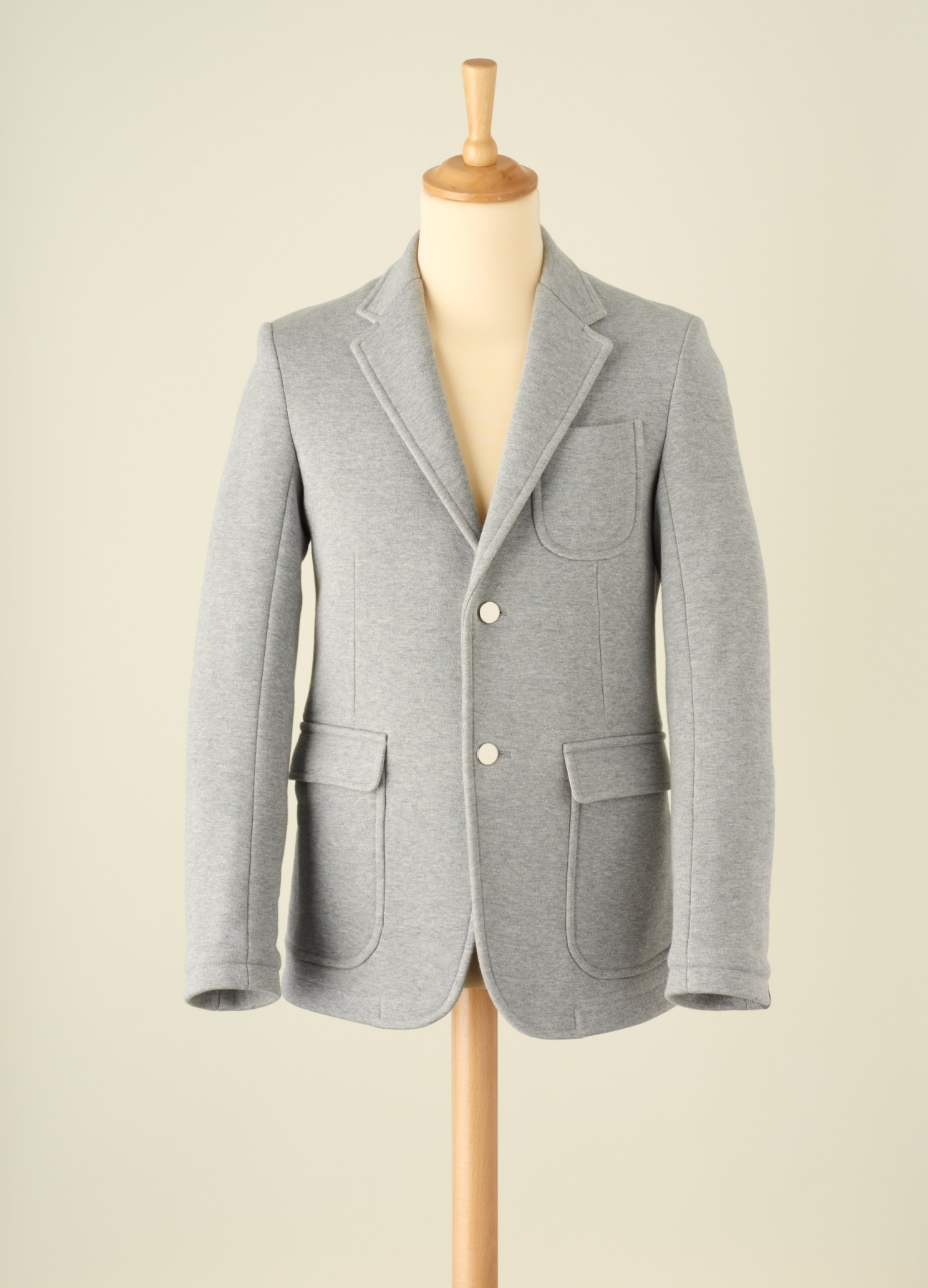 Gray blazer-jumper hybrid by Scye X Loopwheeler displayed on a wooden dress form.