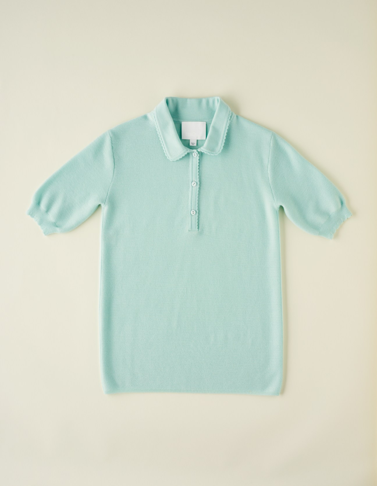 Light turquoise short-sleeved wool polo shirt with white-trimmed collar by Molli.
