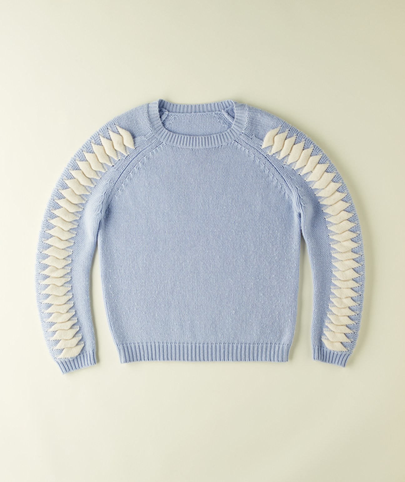 Light blue knit sweater with cream sailing knot details on sleeves from Zoë Jordan's Knitlab collection.