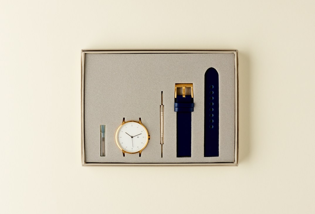 Instrmnt x Dezeen watch set displayed in a branded box with interchangeable straps and tools.