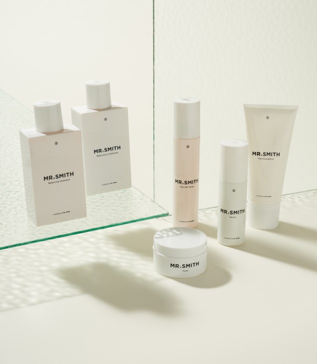 Mr Smith hair products including shampoo, conditioner, serum, and paste in minimalist white packaging.