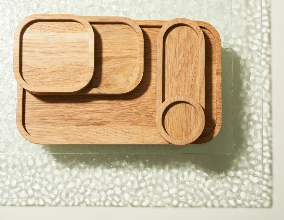 Wooden desktop organiser with rounded compartments in various shapes arranged in a Fibonacci spiral pattern.
