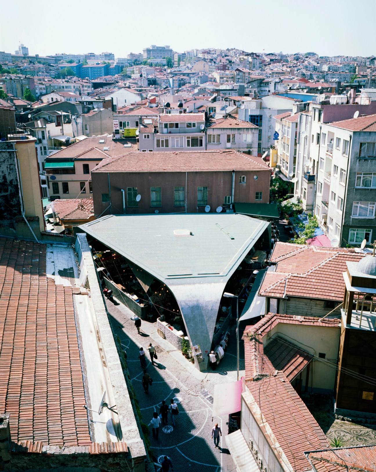 Aerial view of the modern Besiktas Fish Market by GAD Architects surrounded by Istanbul's dense residential buildings.