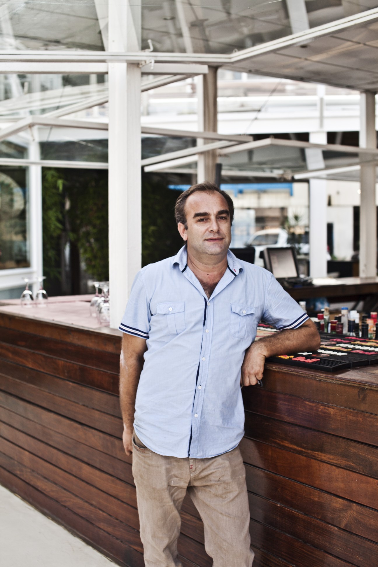 Jaime Maia, 43, manager at Cais de Quatro restaurant in Luanda, standing at the bar.