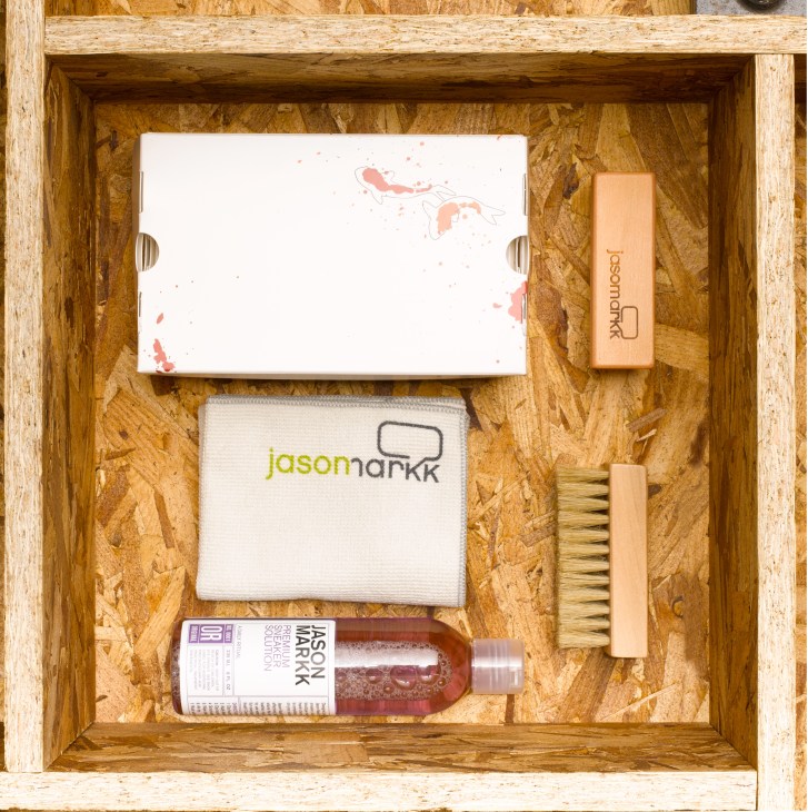 Jason Markk sneaker cleaner kit displayed in wooden box with brush, cloth, solution bottle and instructions.