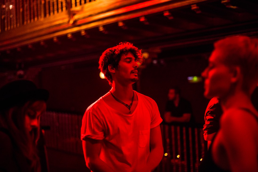 People dancing on a red-lit dancefloor at ChaChá nightclub in Madrid.