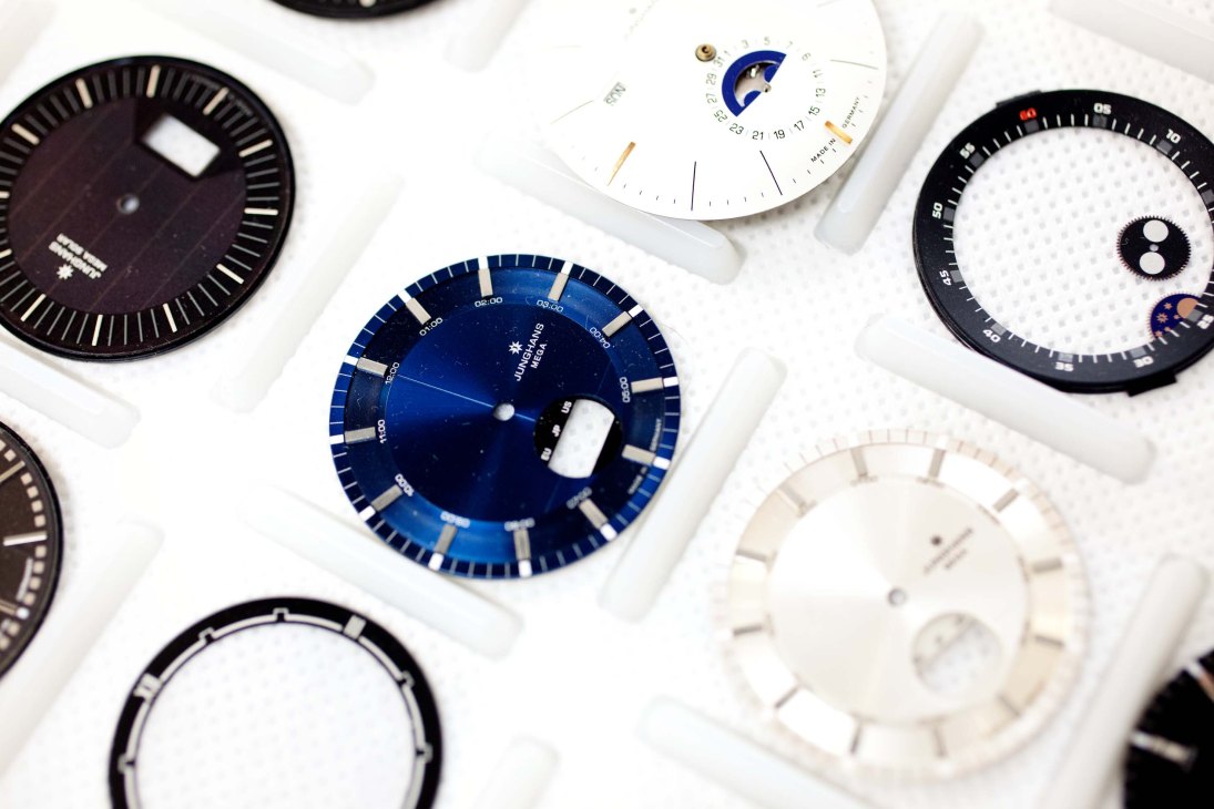 Collection of Junghans watch dials in various styles, featuring black, white, and blue faces with different complications and designs.