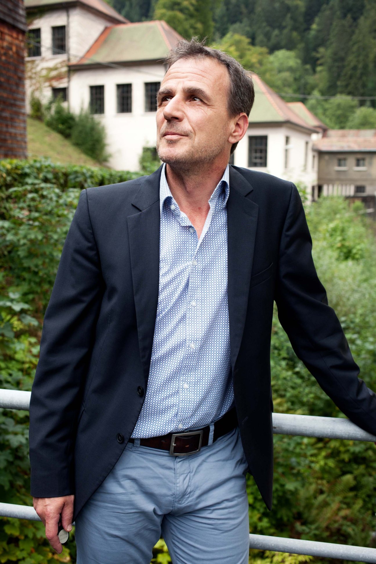 Thomas Fiedler, brand manager at Junghans, standing outdoors with Black Forest buildings in background
