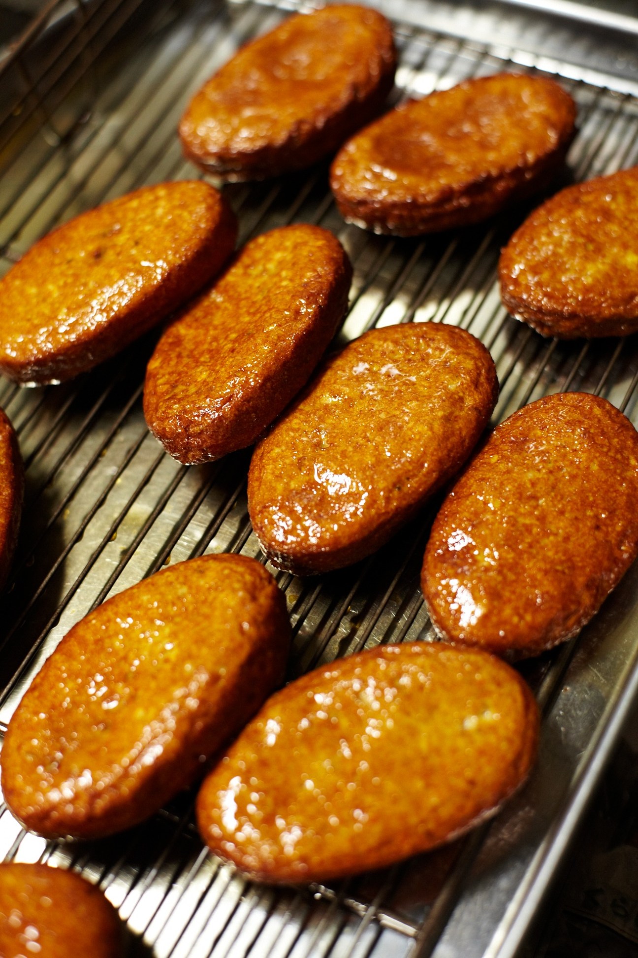 Golden-brown deep-fried Satsuma-age fishcakes on a metal cooling rack.