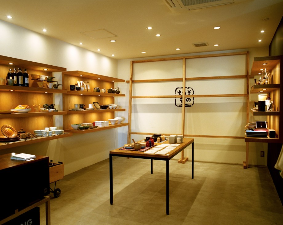 Interior of Good Neighbors shop with wooden shelving, local crafts, and minimalist display furniture.