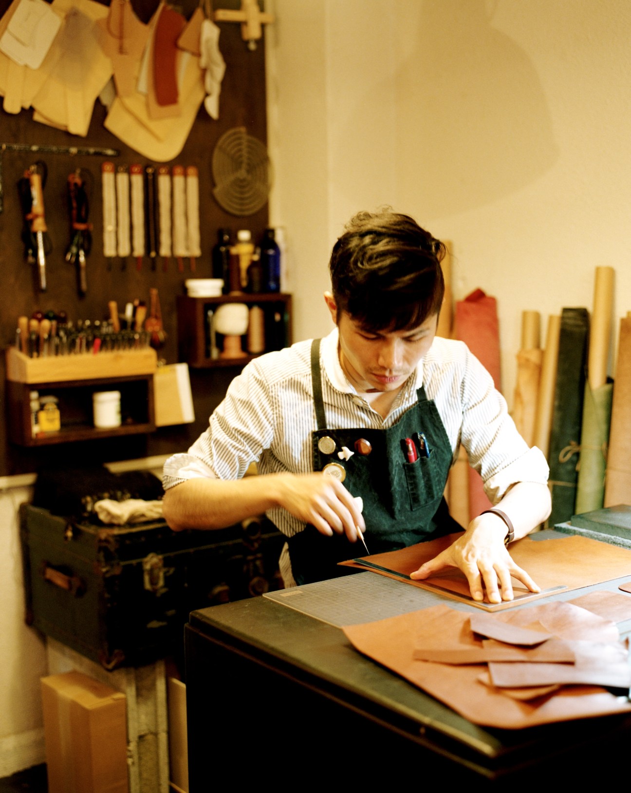 Shoichiro Ibushi hand-stitching leather goods at Rhythm workshop in Kagoshima.