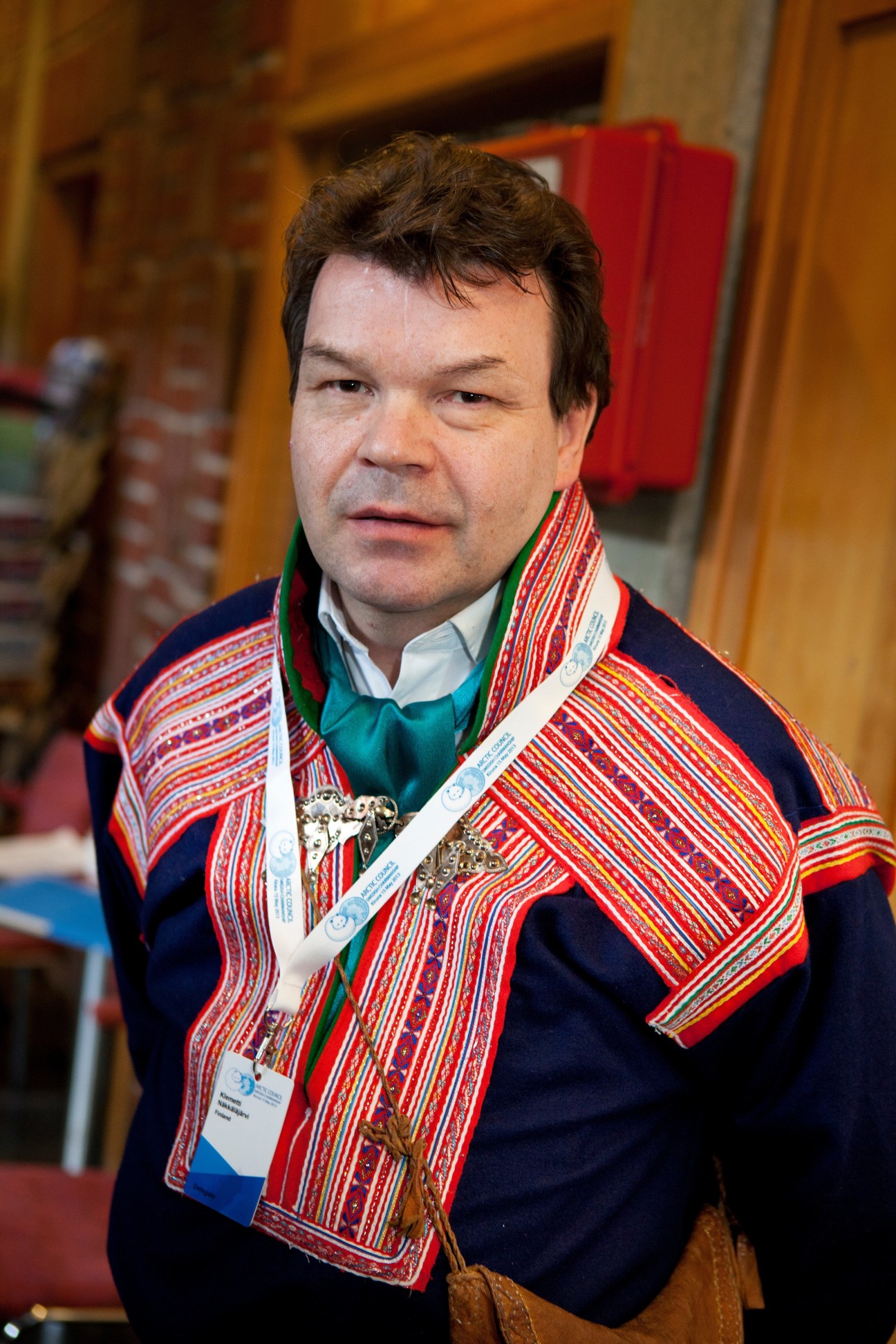 Klemetti Näkkäläjärvi wearing traditional Sami clothing with colorful red and blue patterns at the Arctic Council summit.