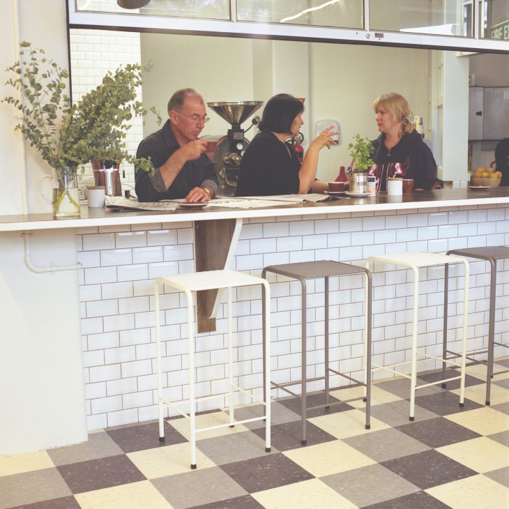 Interior of Kokako café in Auckland with staff behind counter and customers seated at bar.