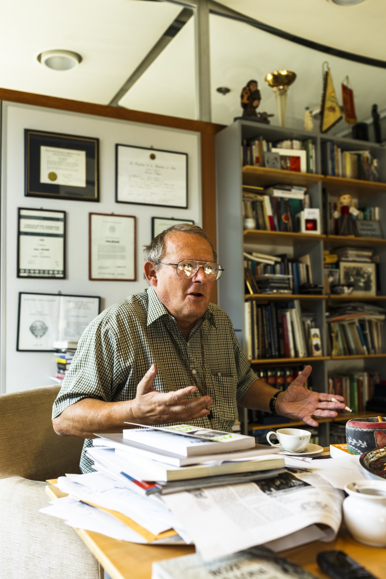Adam Michnik, editor in chief of Gazeta Wyborcza, gestures while speaking in his book-filled office.