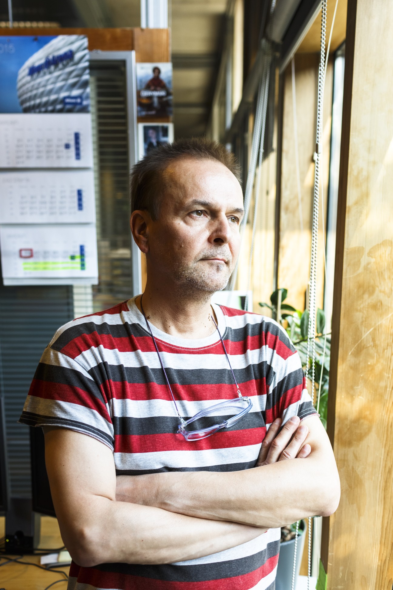 Waldemar Gorlewski, head of the photo department, stands with arms crossed in the Gazeta Wyborcza office.