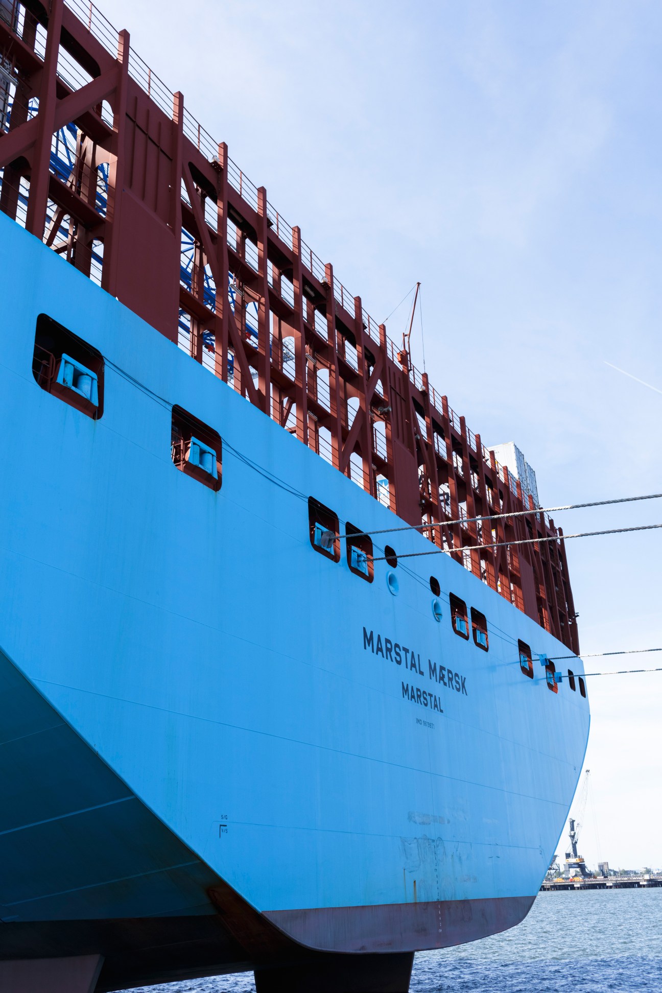 Large blue container ship Marstal Mersk docked at Gdansk's Deepwater Container Terminal.