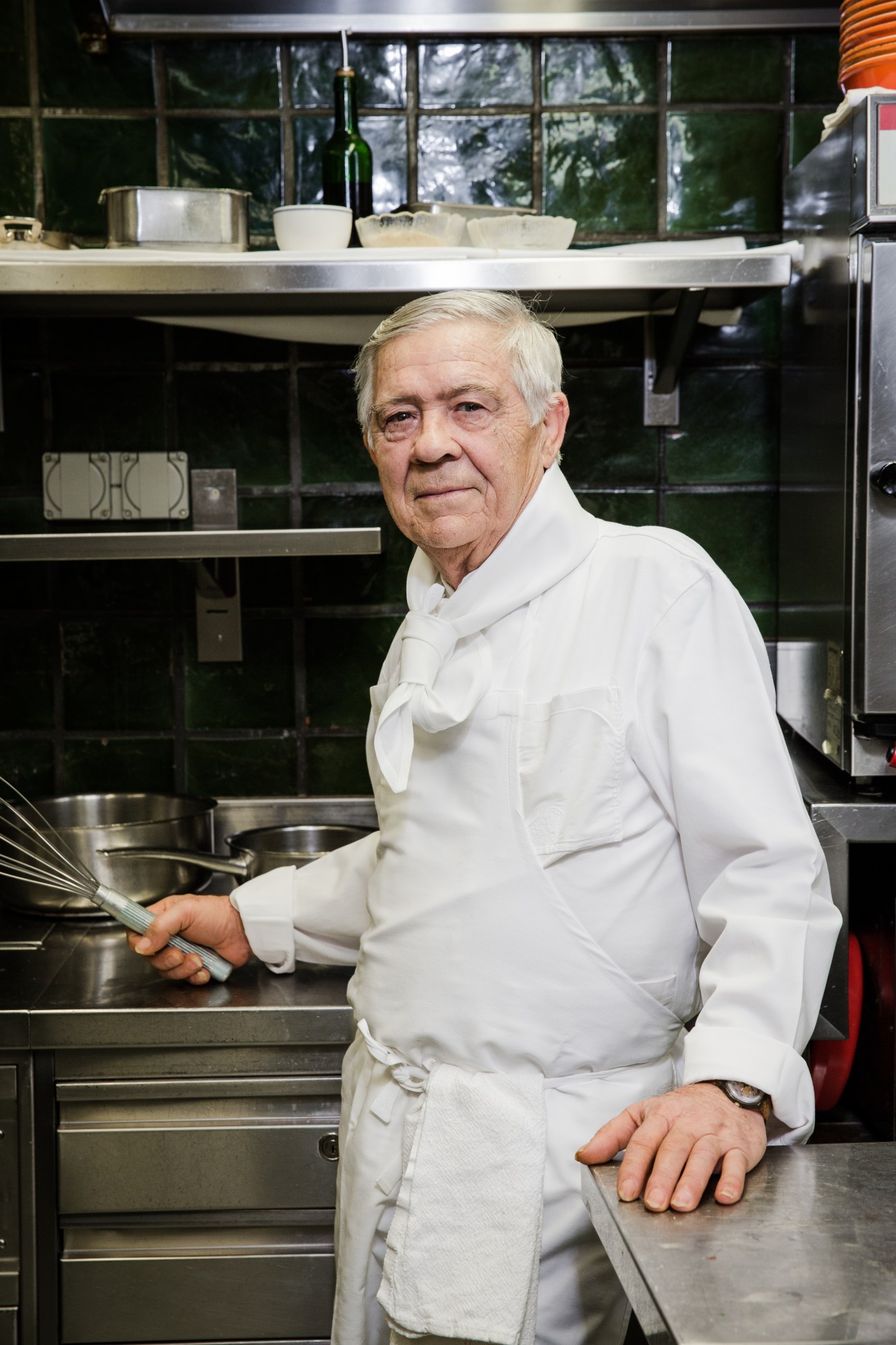 Chef de partie Filippo Abbate in white chef's coat standing in a professional kitchen at Kronenhalle restaurant in Zürich.