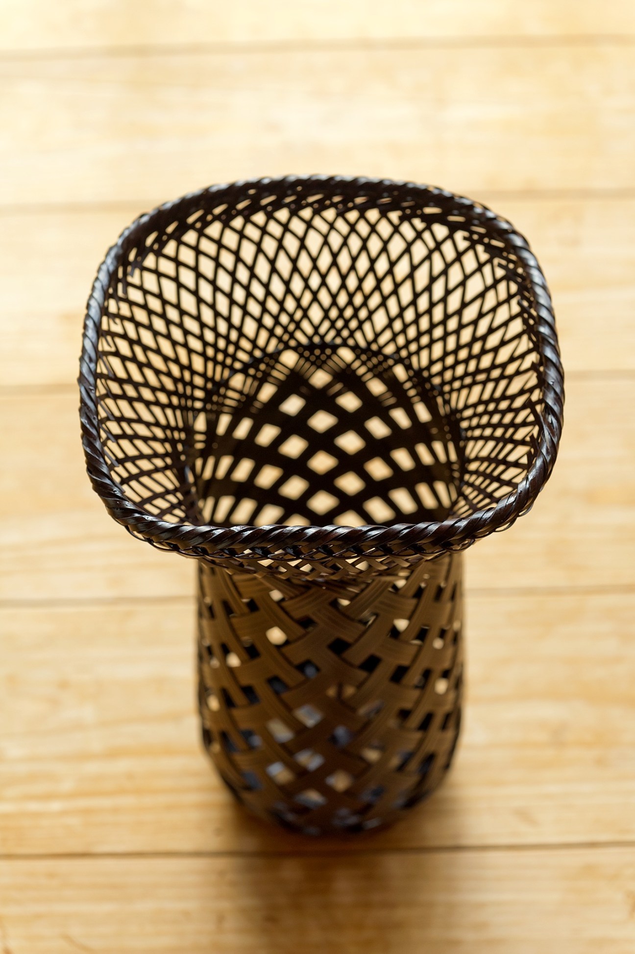Woven bamboo side table with geometric lattice pattern by Tatsuyuki Kosuga.