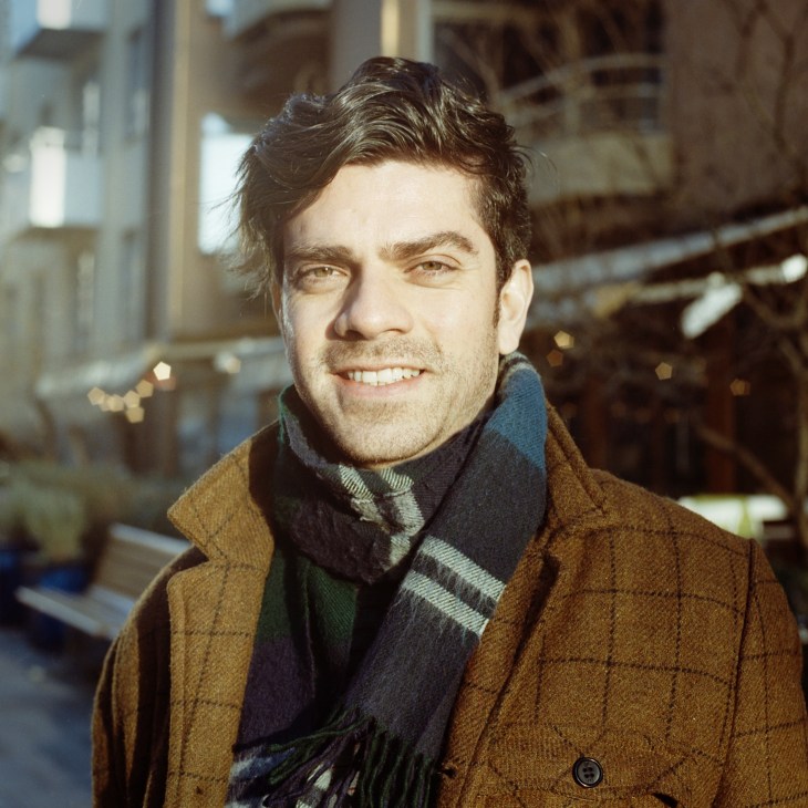 Portrait of architect Fabio Giannuzzi smiling outdoors in Stockholm.
