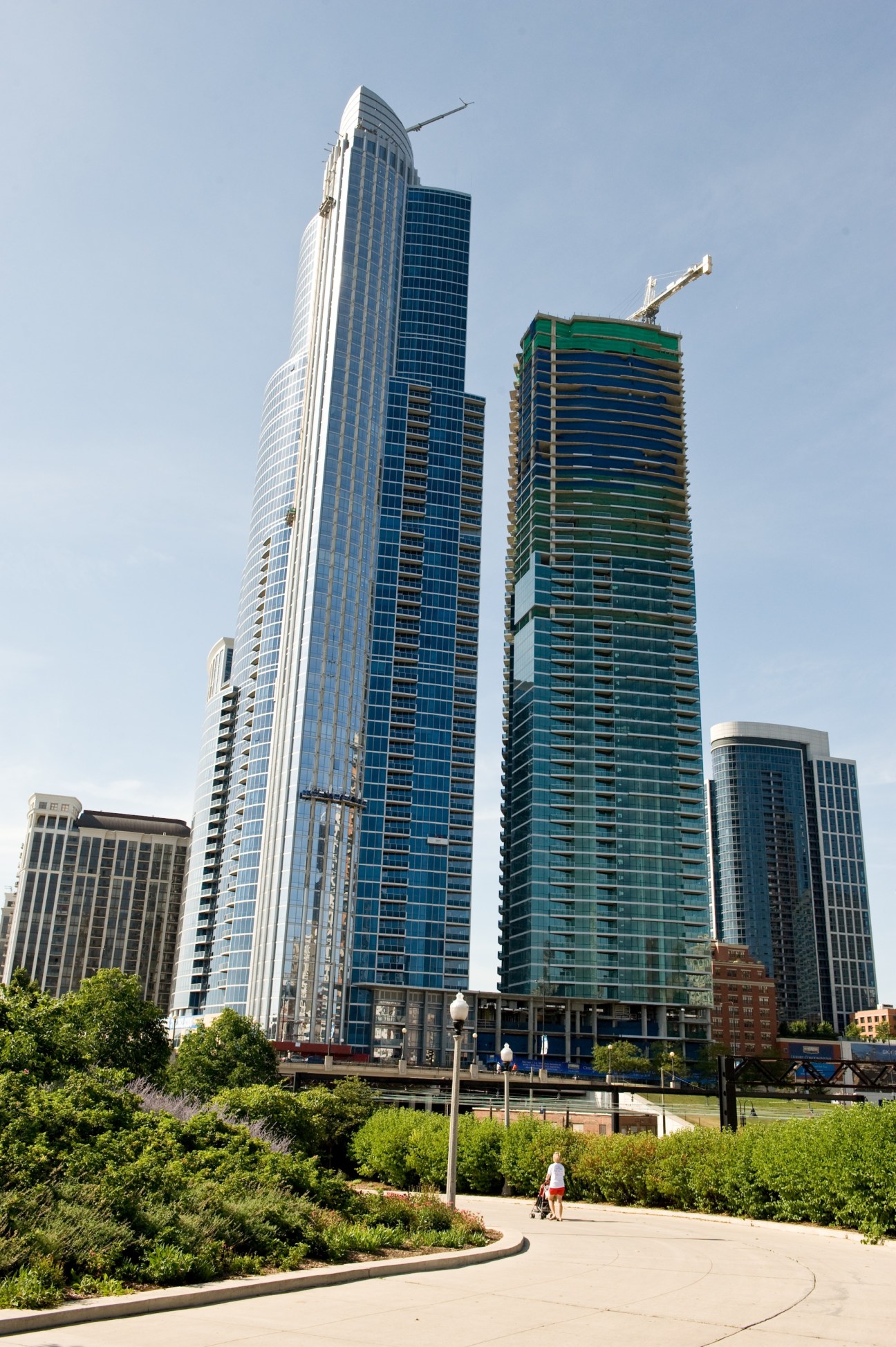 One Museum Park, a 62-floor residential tower in Chicago's South Loop with modern curved architecture alongside other high-rise buildings.