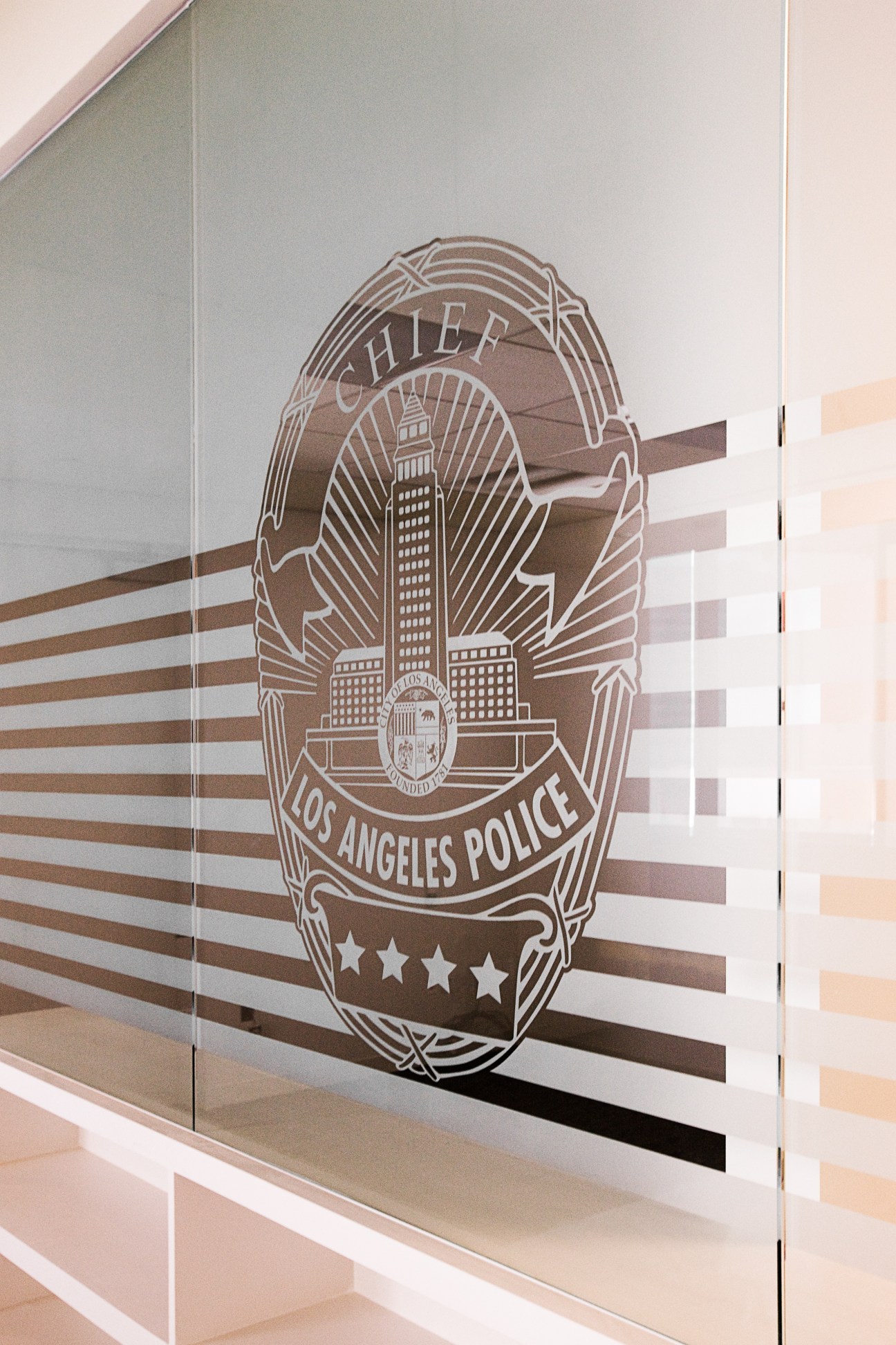 Los Angeles Police Department badge etched on frosted glass in the police chief's office at LAPD headquarters.