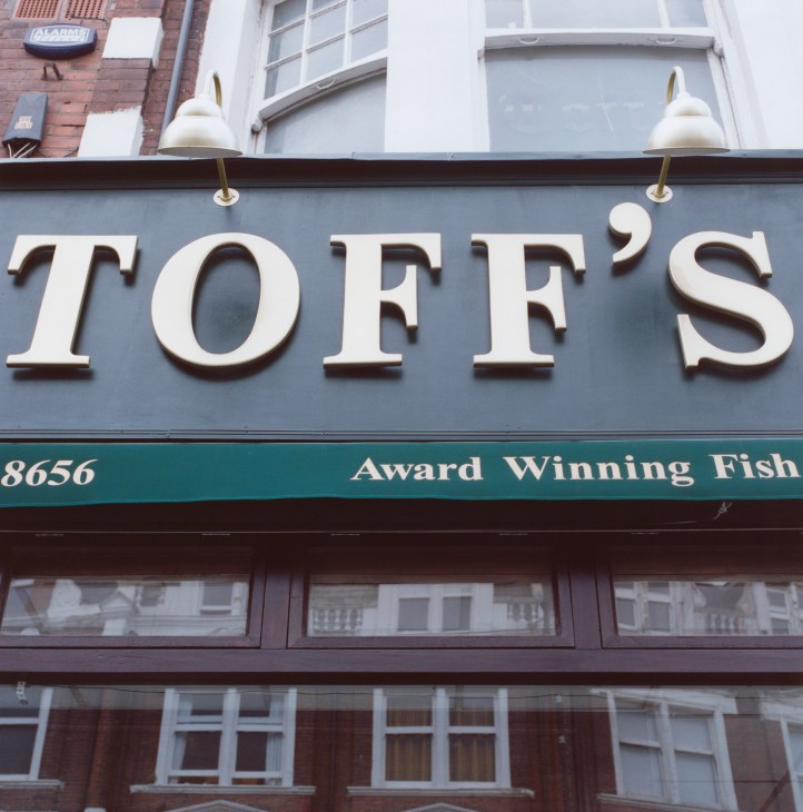 Toff's fish restaurant storefront with large white lettering and 'Award Winning Fish' signage on blue facade.