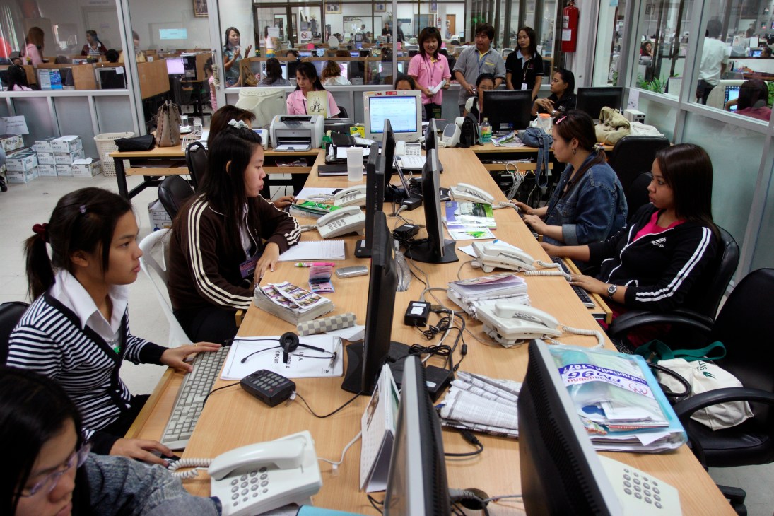RDCK radio station's main information desk with staff members working at computers and phones.