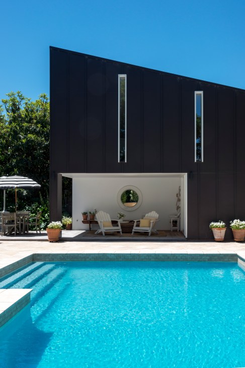 Modern black house with pool and open-plan living space in Braddon, Canberra