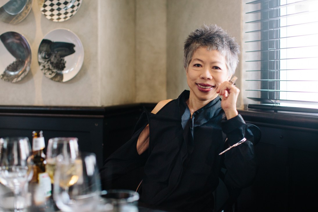 Lee Lin Chin, Australian broadcaster and SBS World News presenter, smiling at a restaurant table.
