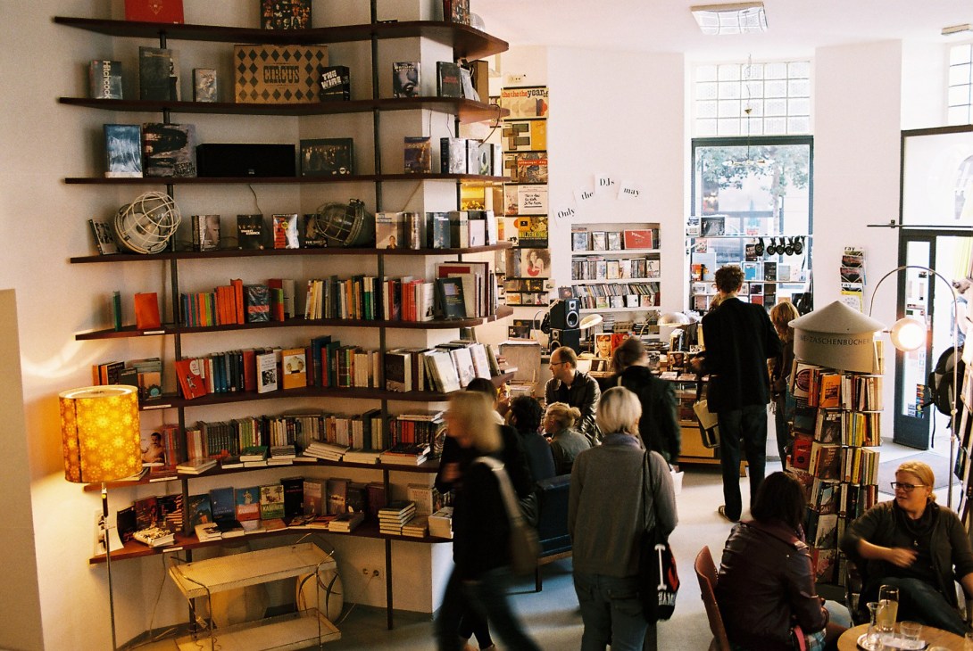 Interior of Phil bookshop with customers browsing shelves of books and media on the walls.