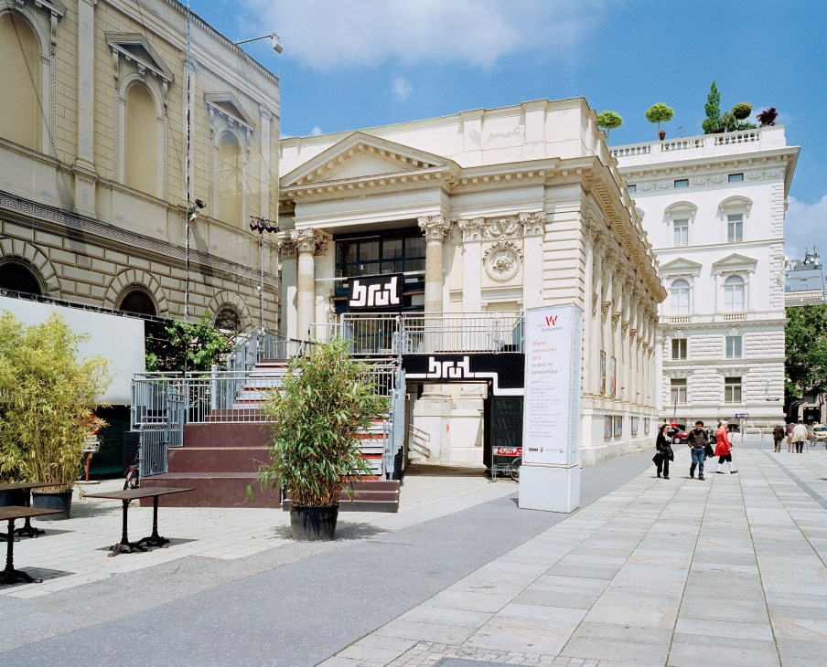 Brut theatre entrance with modern signage on classical Viennese architecture at Karlsplatz.