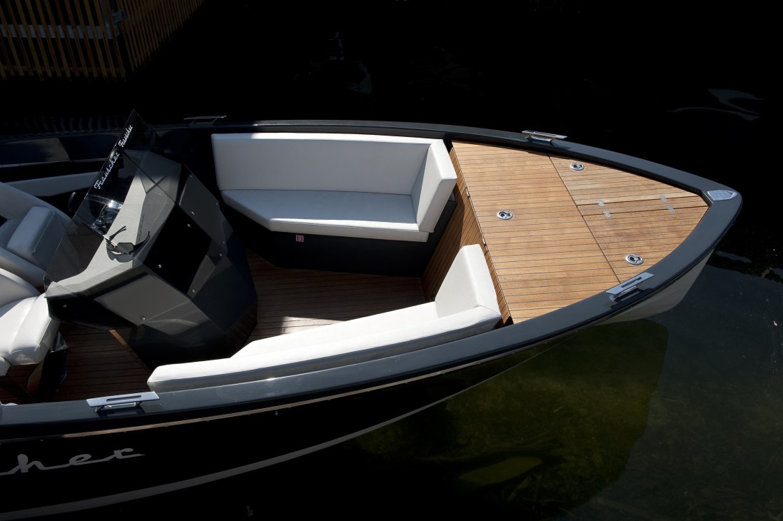 Overhead view of a Frauscher Lido 686 motor boat with teak deck and white upholstered seating.
