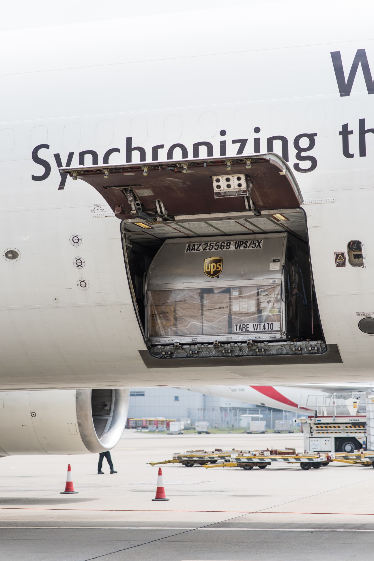 UPS cargo container loaded into aircraft hold at Hong Kong International Airport.