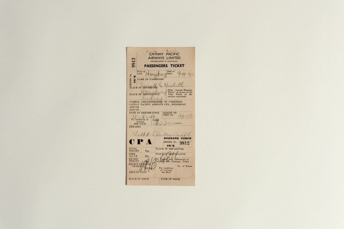 Vintage Cathay Pacific Airways Limited passenger ticket from 1948 with handwritten details and baggage check information.