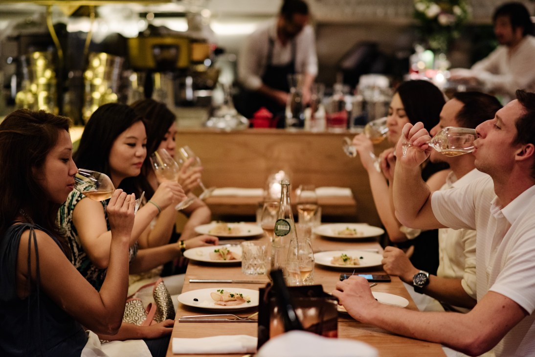Diners enjoy wine and conversation at Serge et Le Phoque restaurant in Hong Kong.