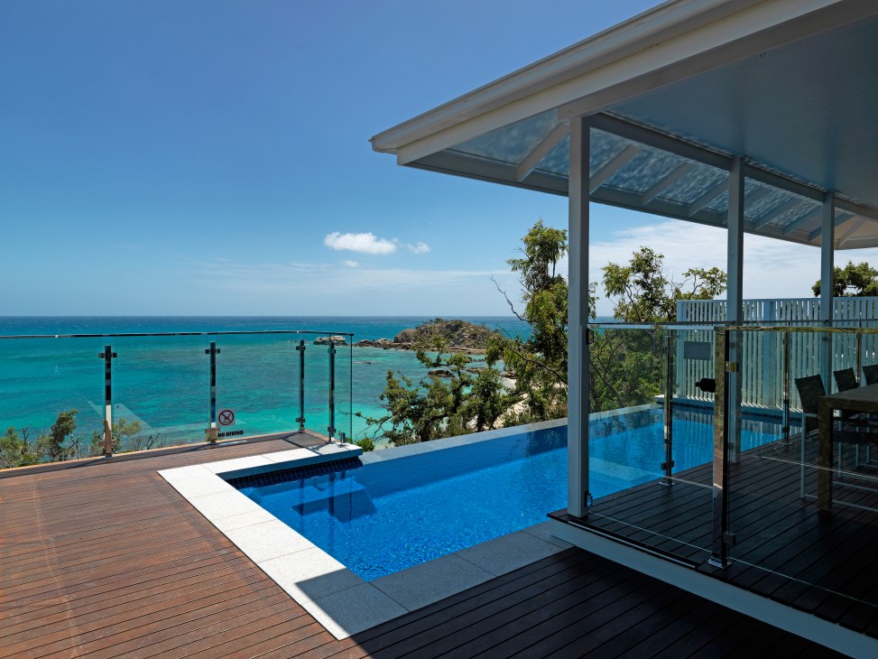 Modern villa with plunge pool overlooking turquoise Coral Sea waters at Lizard Island resort.