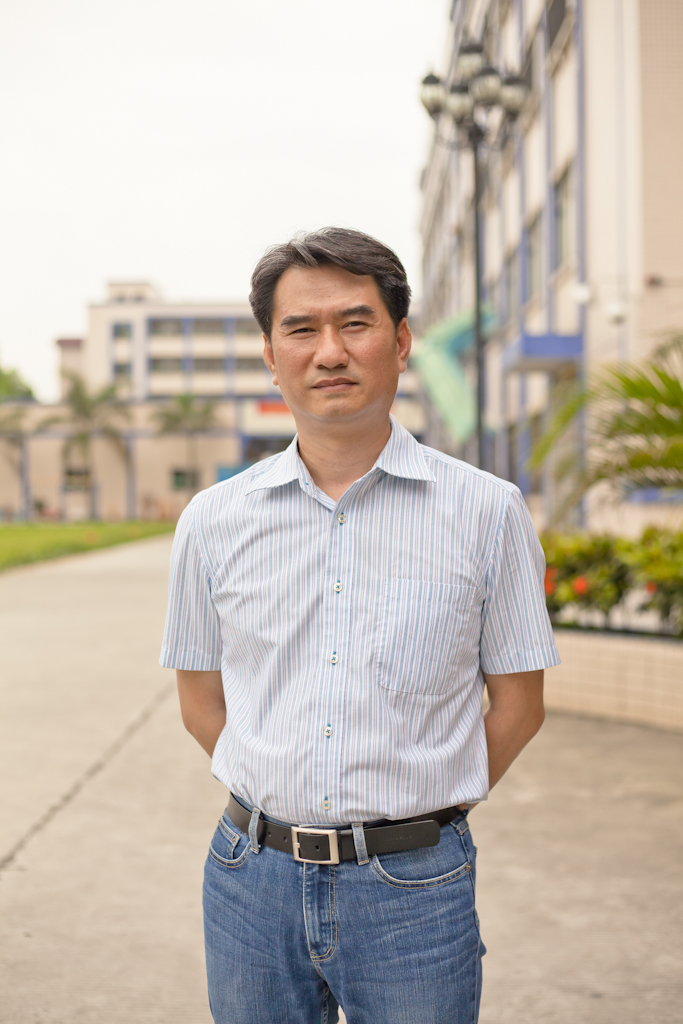 Jacky Yip, manager of Lian Hing clothes factory, stands outside a residential building in Chashan.