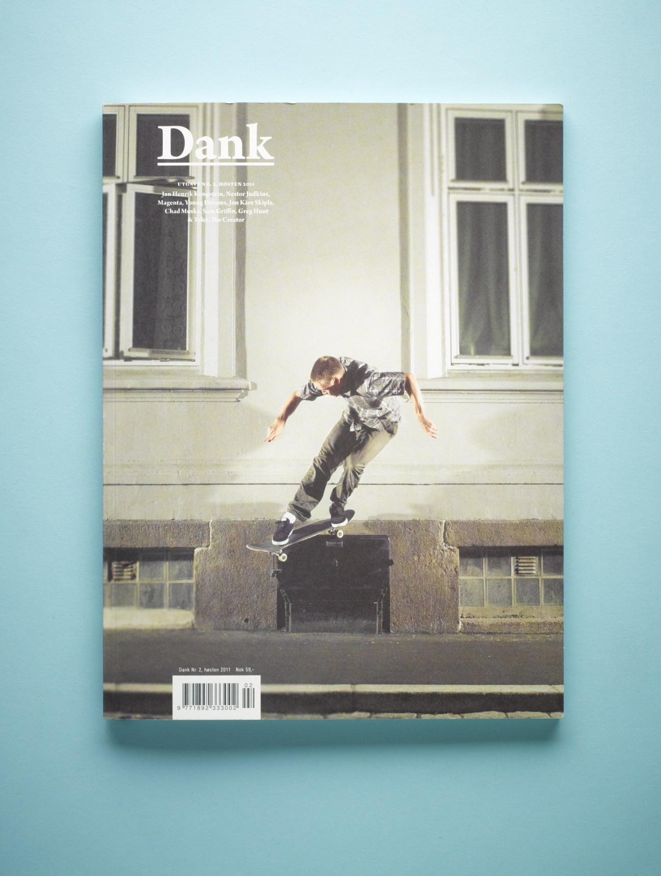 Cover of Dank magazine issue 2 featuring a skateboarder performing a trick on an urban ledge.