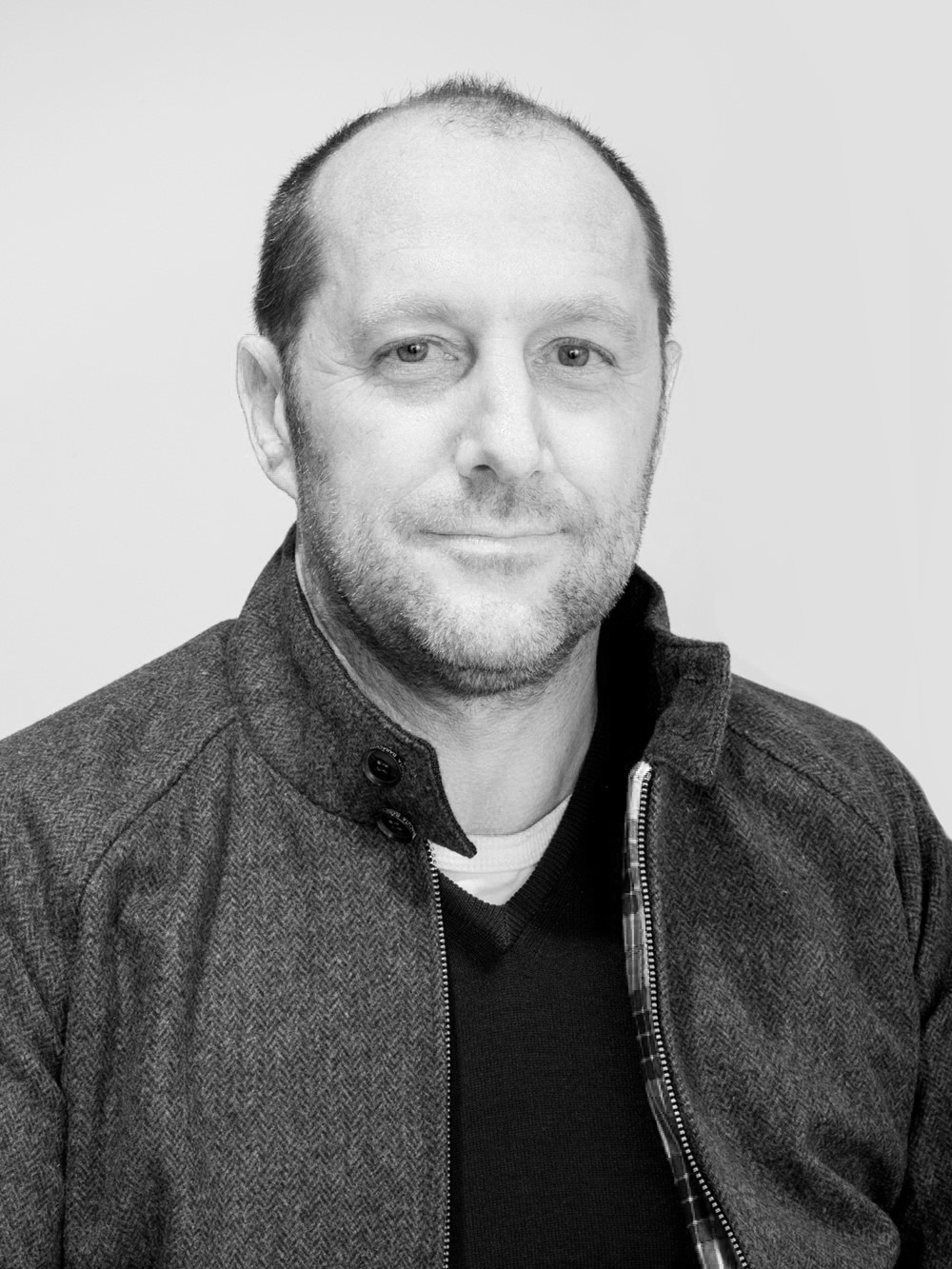 Black and white portrait photograph of Luca Levi, CEO of Baracuta, wearing a grey jacket.